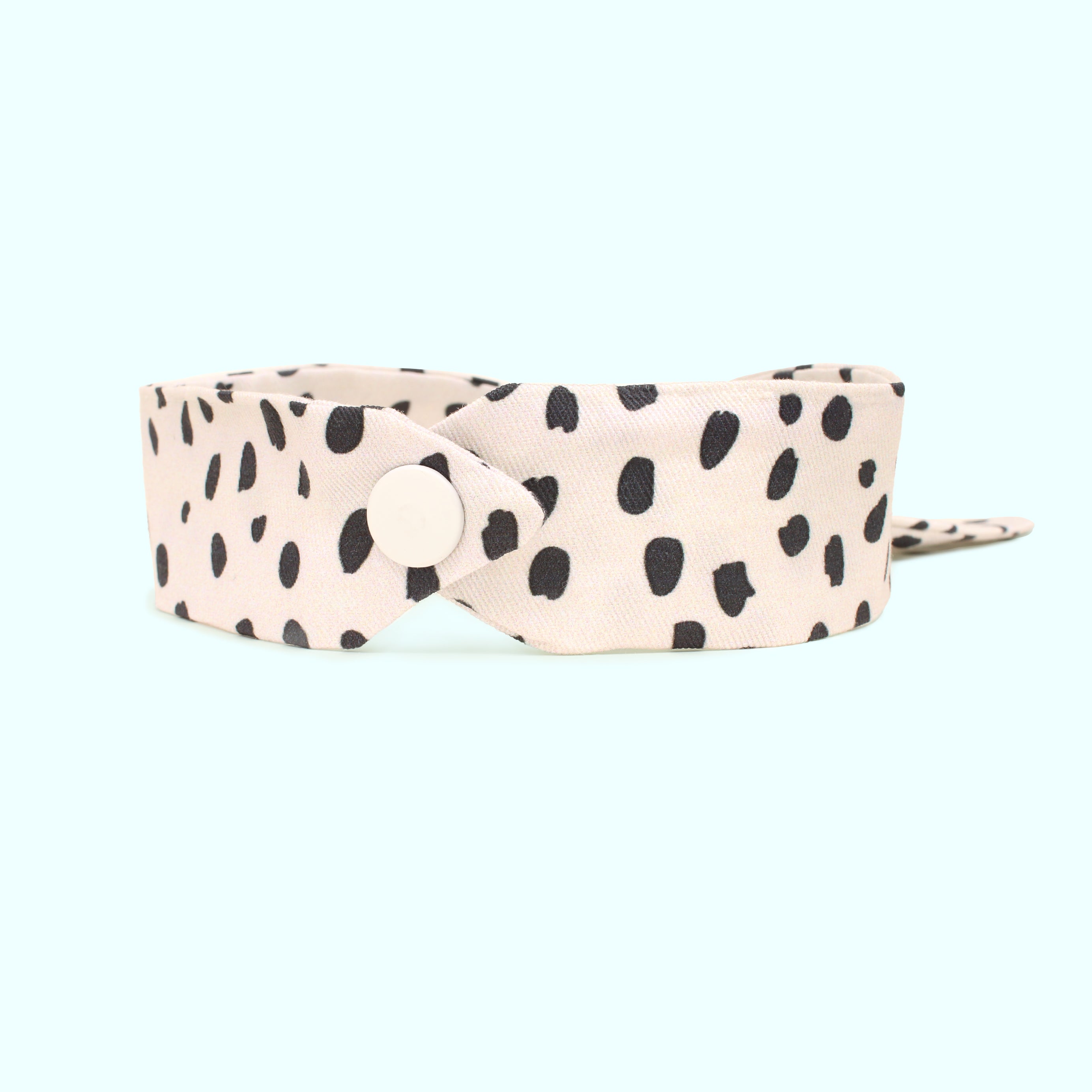 White belt with black polka dots on a white background